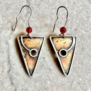 Mixed metal artisan dangle earrings with inventive ear wire to keep in place.